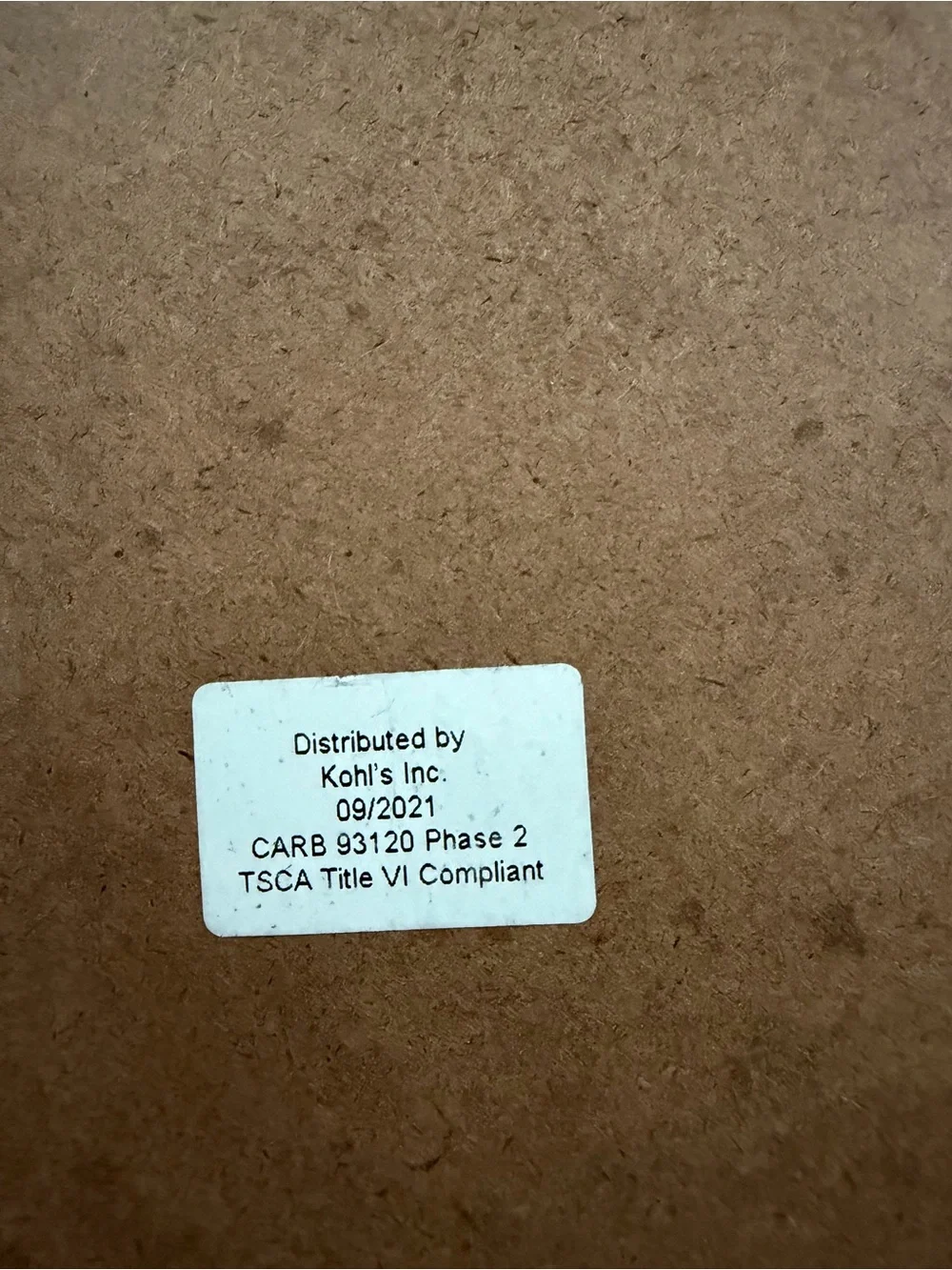 Kohl's Brown MDF Backing with White Compliance Sticker